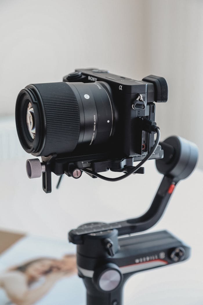 Close-up of a professional camera mounted on a stabilizing gimbal indoors.